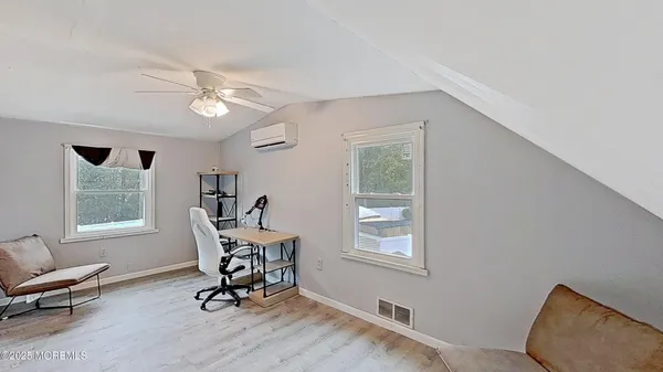 a view of a livingroom with furniture and hardwood floor