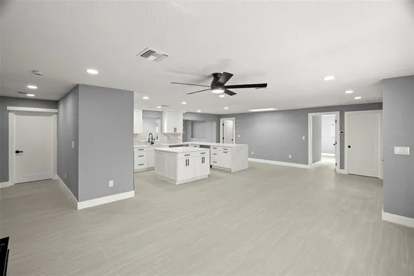 a view of a kitchen with furniture and a ceiling fan