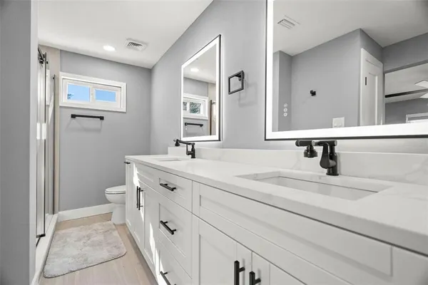 a spacious bathroom with a sink and a mirror