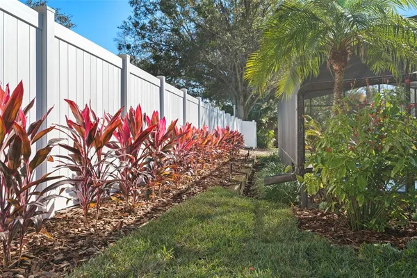 a view of a house with backyard and a tree