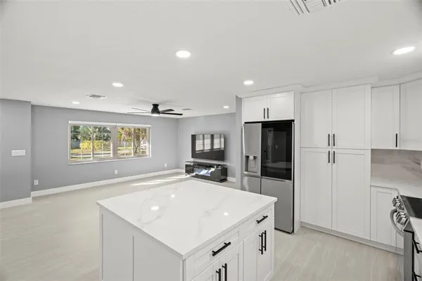 a kitchen with stainless steel appliances a refrigerator sink and microwave