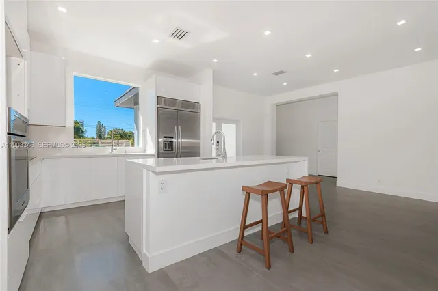 a kitchen with a table and chairs in it