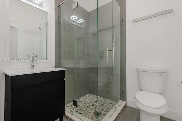 a bathroom with a shower sink and toilet