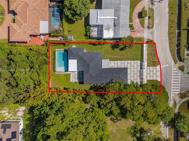 an aerial view of a house with a yard and garden