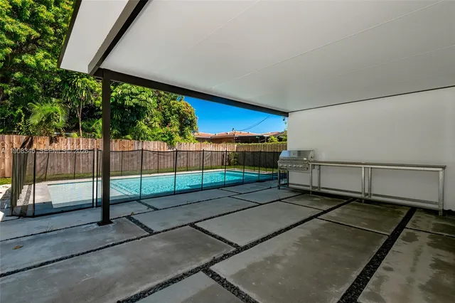 a view of a backyard with a garden and entertaining space