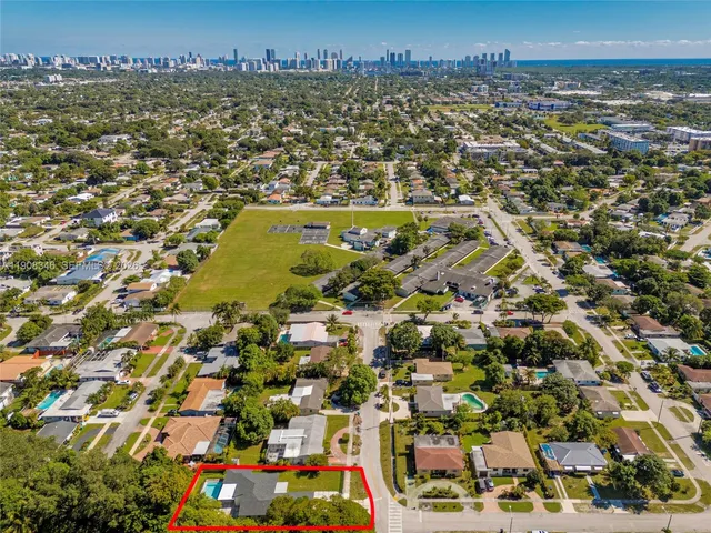 a kitchen with table chairs sink and cabinets
