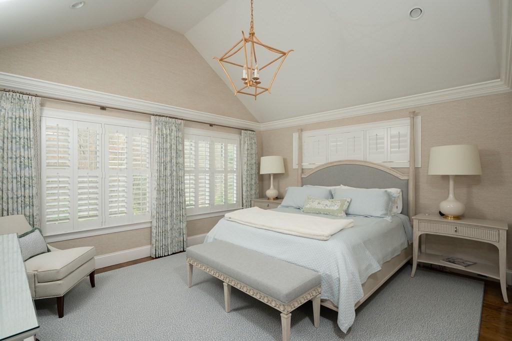 155 Black Rock Drive, Unit 155 Hingham, MA 02043 - Photo 21 of 42 a bedroom with a bed and a chandelier