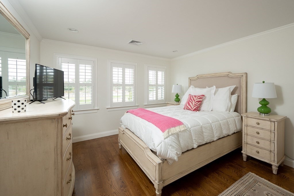 155 Black Rock Drive, Unit 155 Hingham, MA 02043 - Photo 25 of 42 a bedroom with a large bed and a flat tv screen on dresser