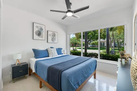 a bedroom with a large bed and a large window