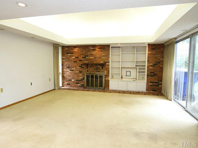 3205 Caldwell Drive Raleigh, NC 27607 - Photo 6 of 14 Large family with 2nd fireplace, just off kitchen. View of private patio off den and breakfast room Den/Family/Great Room