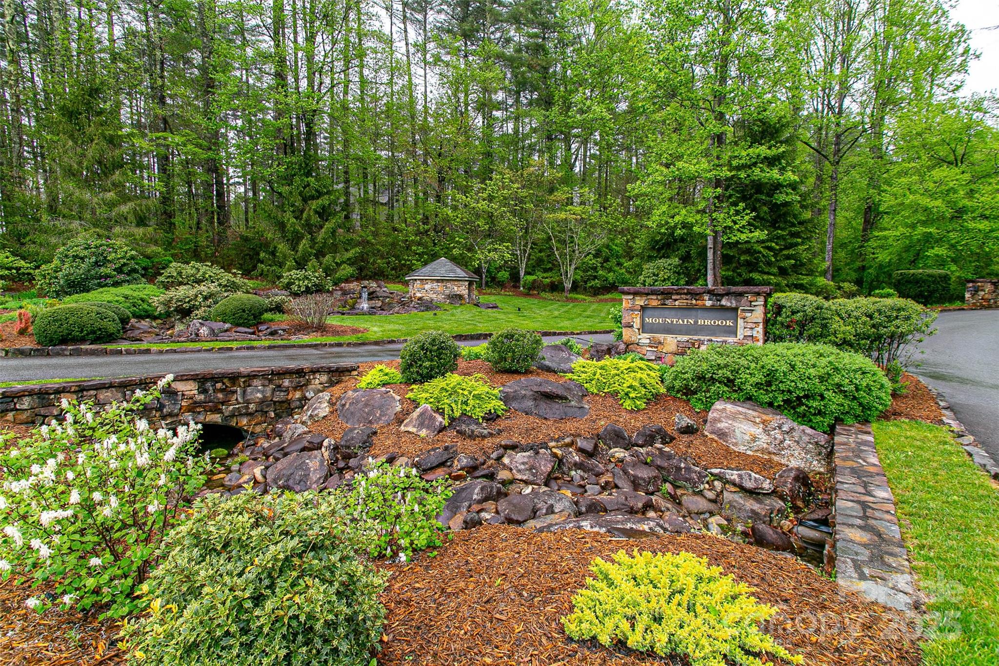Tbd High Hemlock Trail, Unit 46 Brevard, NC 28712 - Photo 19 of 21 a view of a garden with a bench