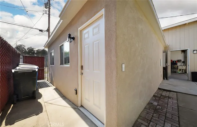 a kitchen with cabinets stainless steel appliances and wooden floor