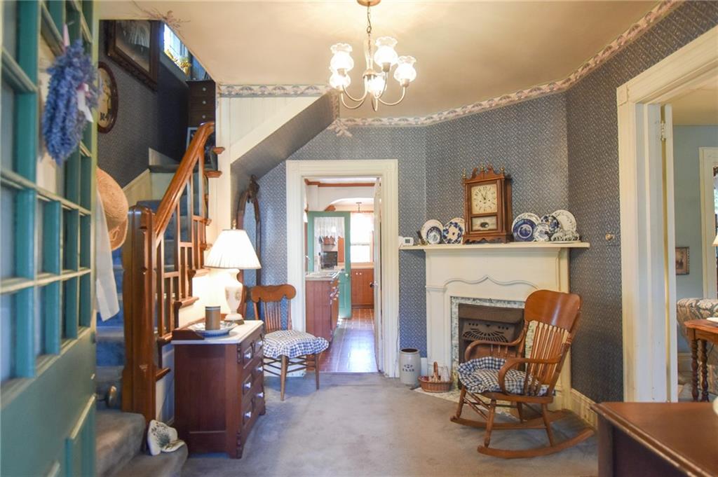 315 4th Street Freeport, PA 16229 - Photo 4 of 17 a living room with furniture a fireplace and a chandelier