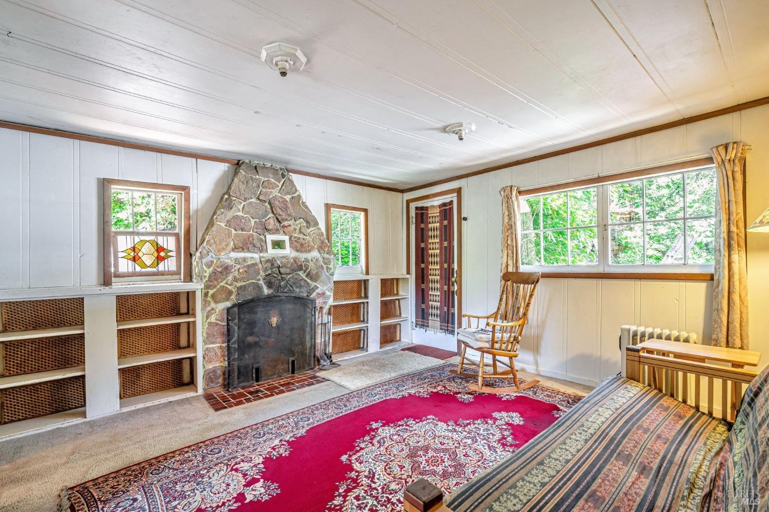 1561 South Fitch Mountain Road Healdsburg, CA 95448 - Photo 13 of 44 a living room with furniture a rug and a large window