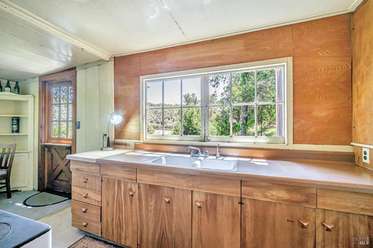 1561 South Fitch Mountain Road Healdsburg, CA 95448 - Photo 15 of 44 a bathroom with a sink and a large window