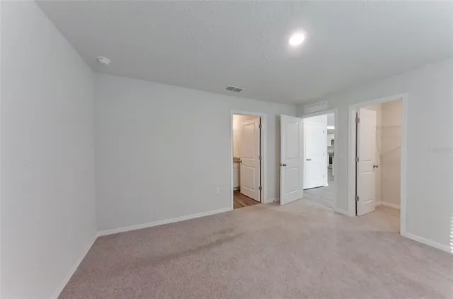 a bathroom with a granite countertop double vanity sink and a mirror
