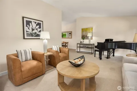 a living room with furniture and a dining table