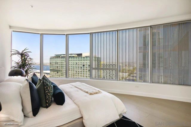 a bed sitting in a bedroom next to a window