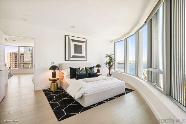 a bedroom with a bed and a large window