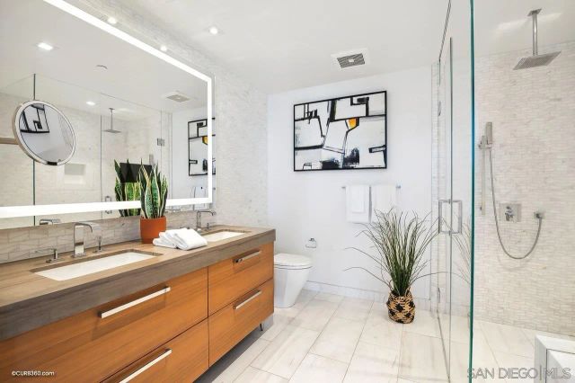 a spacious bathroom with a granite countertop sink and a mirror