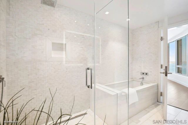 a bathroom with a bathtub and a shower