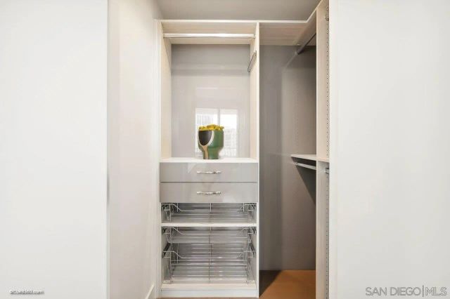 a view of walk in closet with empty room