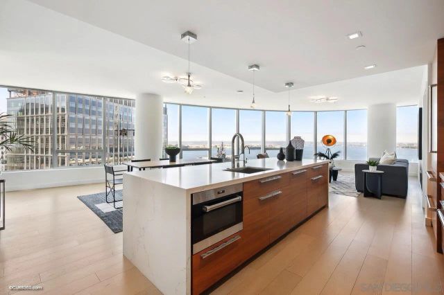 a large living room with stainless steel appliances kitchen island granite countertop a large counter top stainless steel appliances and cabinets