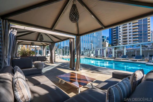 a view of a patio with a dining table and chairs under an umbrella