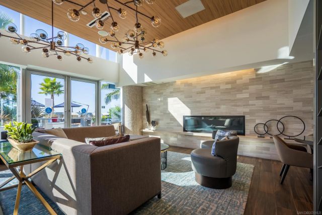 a living room with furniture a chandelier and a fireplace