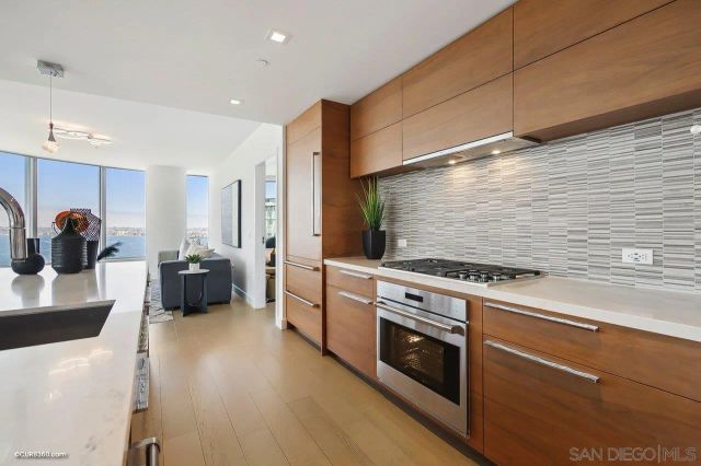 a kitchen with stainless steel appliances a stove a sink a refrigerator and cabinets