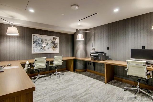 a view of a workspace with furniture and wooden floor