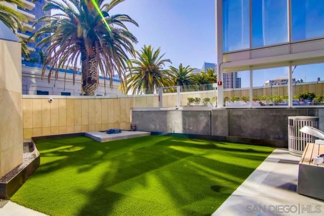 a view of backyard with swimming pool and seating area