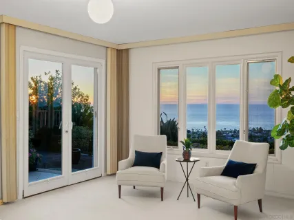 a living room with furniture and a floor to ceiling window