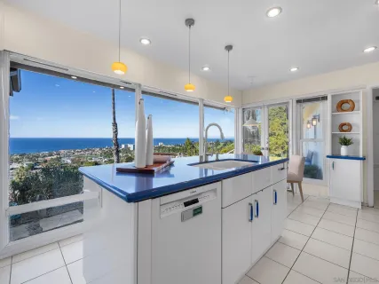 a kitchen with counter top space and windows