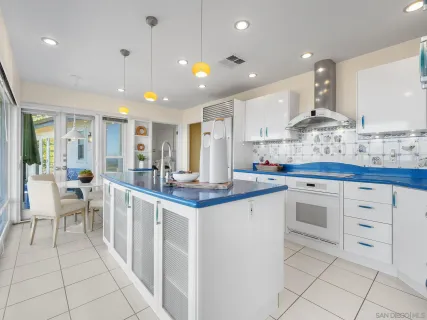 a kitchen with stainless steel appliances kitchen island granite countertop a stove a sink and a refrigerator