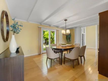 a view of a dining room with furniture and window