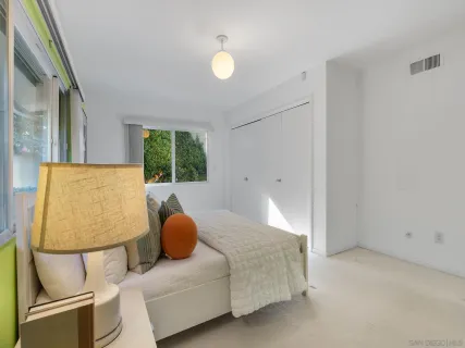 a bedroom with a bed and window