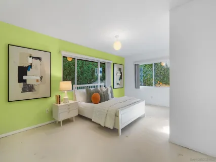 a bed room with a bed and a large window