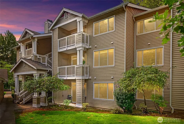 a front view of a house with a yard and potted plants