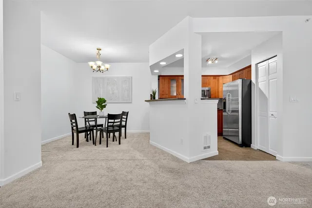 a view of dining room with furniture and a chandelier
