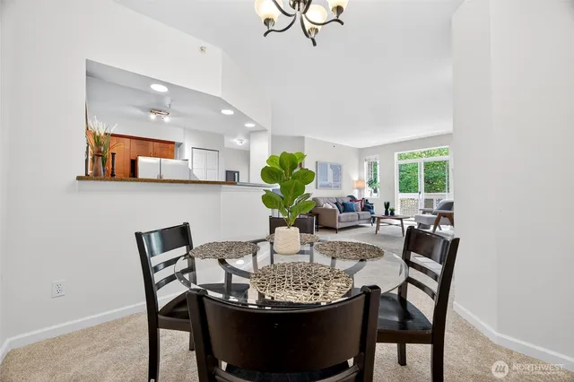 a view of a dining room with furniture and a potted plant
