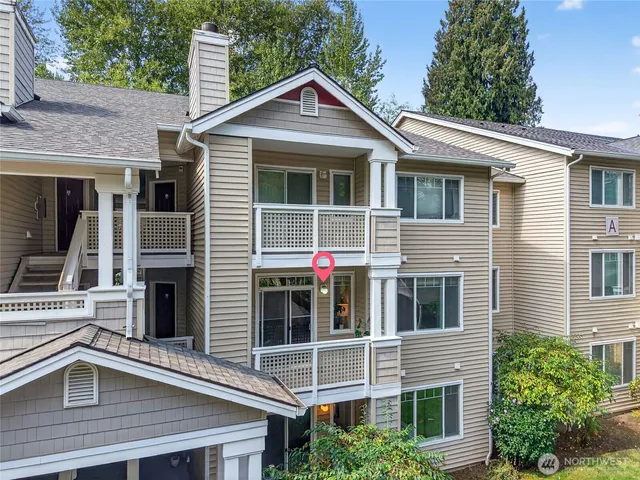 a view of a house with a yard and potted plants