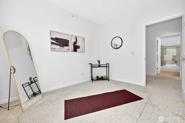 a view of a room with furniture and mirror