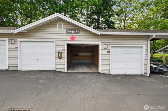 a view of a house with a garage and a yard