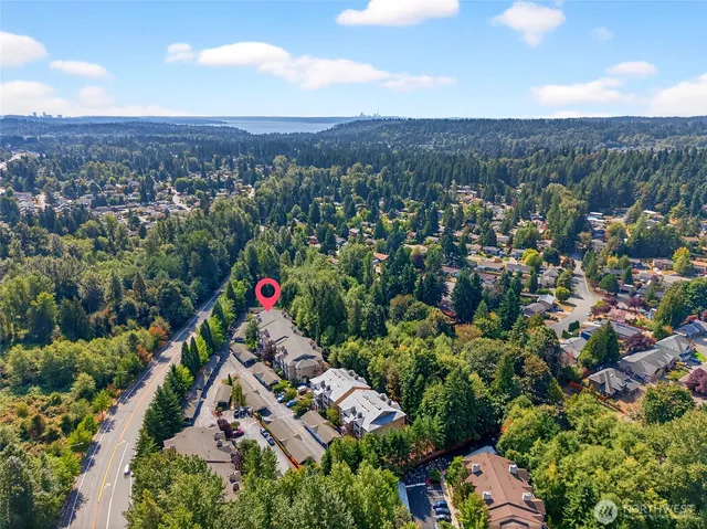 an aerial view of house with yard and mountain view in back