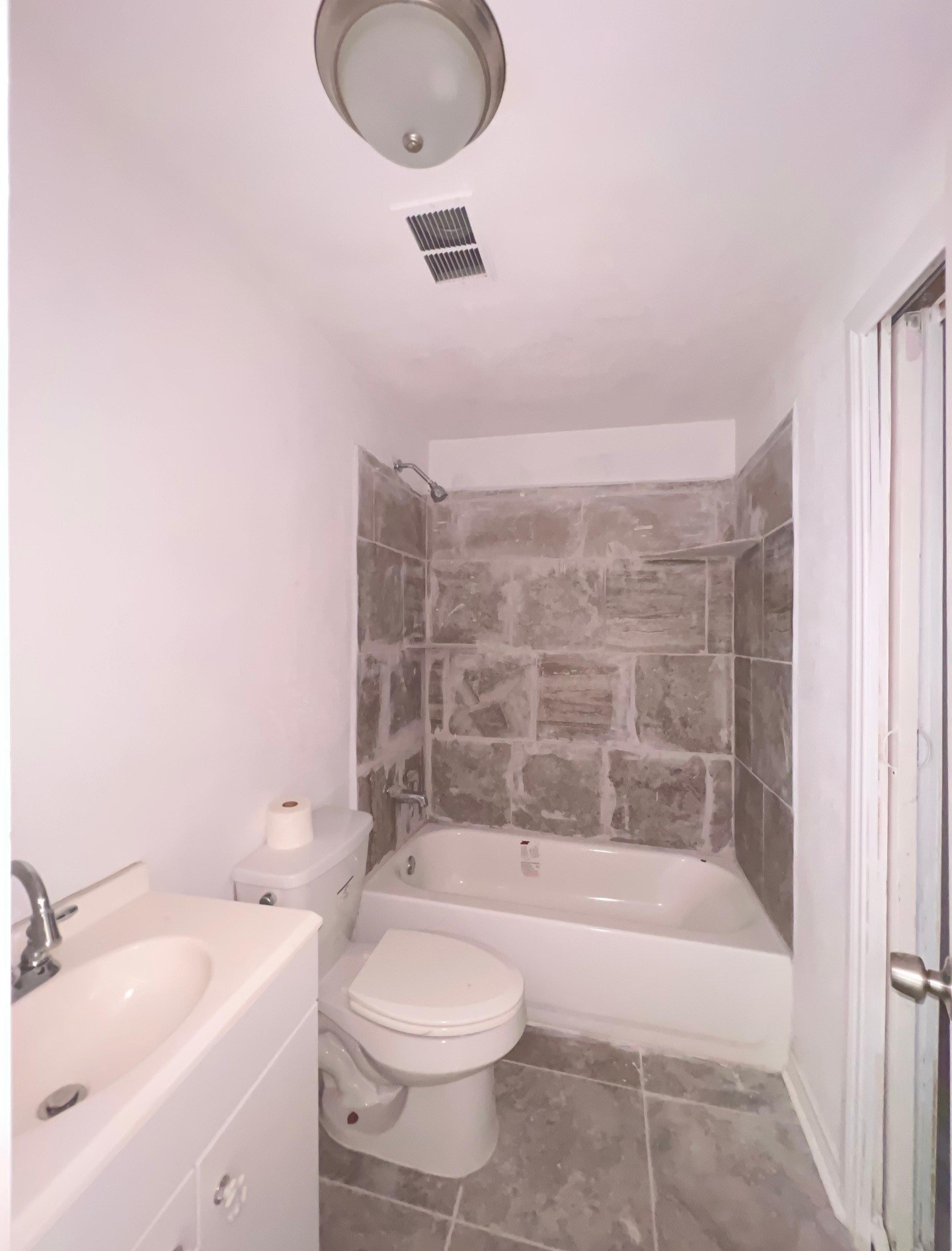 3121 Bond Street Pasadena, TX 77503 - Photo 14 of 16 a bathroom with a granite countertop sink a toilet and bathtub