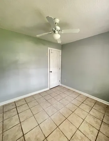 a view of an empty room and wooden floor