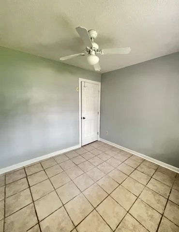 a view of an empty room and wooden floor