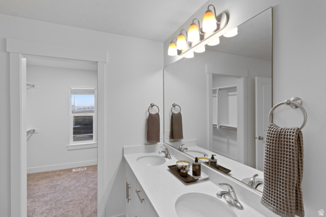 3003 South 265th Street West, Unit 751 Logan, UT 84321 - Photo 27 of 29 Full bath with double vanity and light carpet