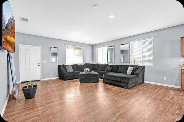 a living room with furniture window and wooden floor